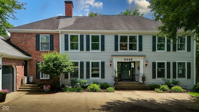 4443 Mallard Pt, Columbus, IN 47201 - view of front of house featuring a chimney and brick siding