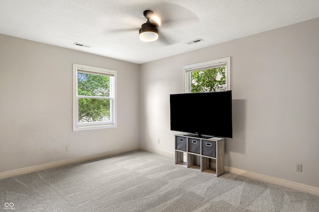 4443 Mallard Pt, Columbus, IN 47201 - unfurnished living room with ceiling fan, carpet floors, and a textured ceiling
