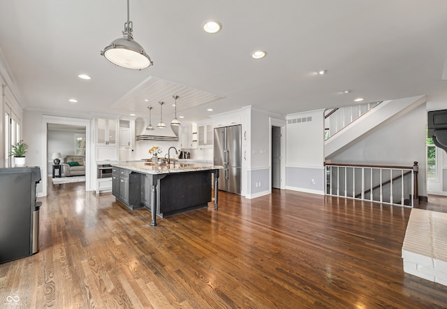 4443 Mallard Pt, Columbus, IN 47201 - kitchen with stainless steel refrigerator, white cabinetry, an island with sink, glass insert cabinets, and recessed lighting