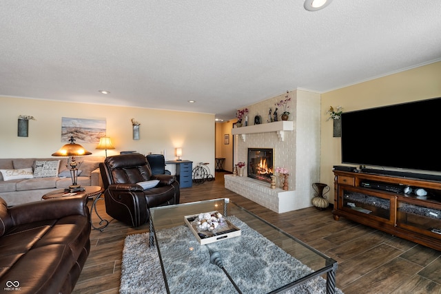 4443 Mallard Pt, Columbus, IN 47201 - living area featuring a textured ceiling, a fireplace, dark wood-style floors, and recessed lighting
