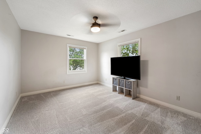 4443 Mallard Pt, Columbus, IN 47201 - unfurnished living room with carpet flooring, ceiling fan, and a textured ceiling