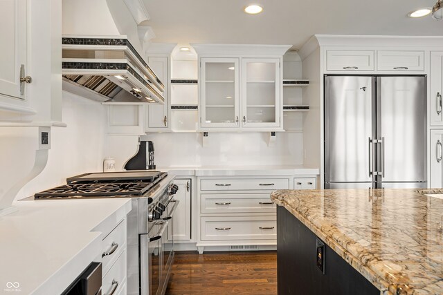 4443 Mallard Pt, Columbus, IN 47201 - kitchen with appliances with stainless steel finishes, custom exhaust hood, white cabinets, recessed lighting, and glass insert cabinets
