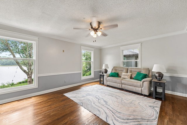 4443 Mallard Pt, Columbus, IN 47201 - living room with a ceiling fan, dark wood-style flooring, a textured ceiling, and ornamental molding