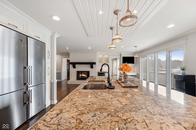 4443 Mallard Pt, Columbus, IN 47201 - kitchen with high end refrigerator, light stone countertops, crown molding, white cabinetry, and recessed lighting