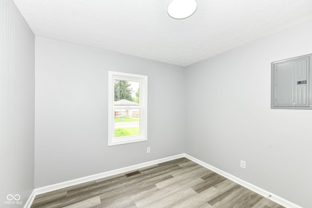 2413 Fowler St, Anderson, IN 46012 - empty room featuring electric panel and wood finished floors