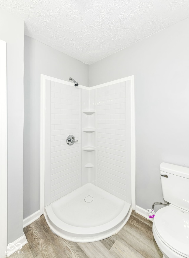 2413 Fowler St, Anderson, IN 46012 - full bathroom with wood finished floors, tiled shower, and a textured ceiling