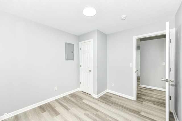 2413 Fowler St, Anderson, IN 46012 - unfurnished bedroom with electric panel and light wood-style floors