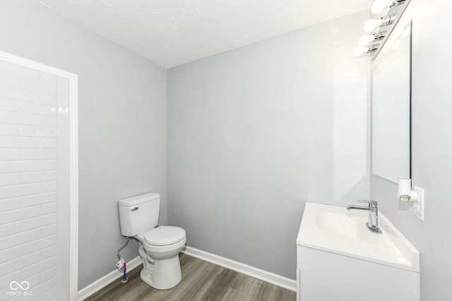 2413 Fowler St, Anderson, IN 46012 - bathroom with vanity, wood finished floors, and a textured ceiling