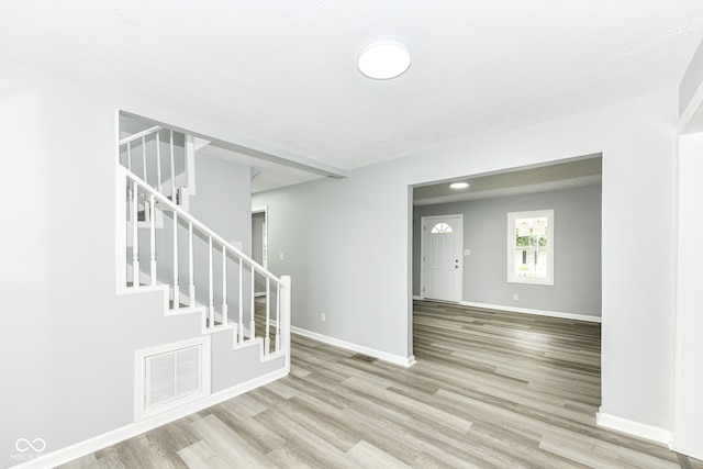2413 Fowler St, Anderson, IN 46012 - empty room with wood finished floors and stairway