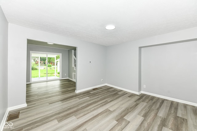 2413 Fowler St, Anderson, IN 46012 - empty room featuring wood finished floors and a textured ceiling