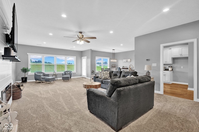 3072 W Glacier Dr, Monrovia, IN 46157 - living area featuring light carpet, a ceiling fan, a fireplace, and recessed lighting