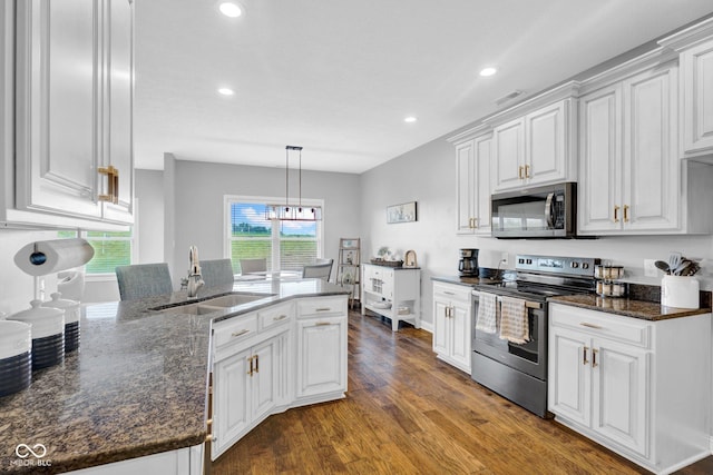 3072 W Glacier Dr, Monrovia, IN 46157 - kitchen with stainless steel appliances, white cabinets, dark wood finished floors, recessed lighting, and dark stone countertops