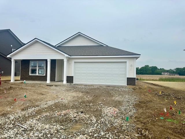 6812 Rawlings Ln, Indianapolis, IN 46221 - ranch-style house with a garage, driveway, a porch, and a shingled roof