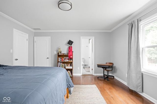 7629 Candlewood Ln, Indianapolis, IN 46250 - bedroom featuring light wood-type flooring, ornamental molding, and ensuite bath