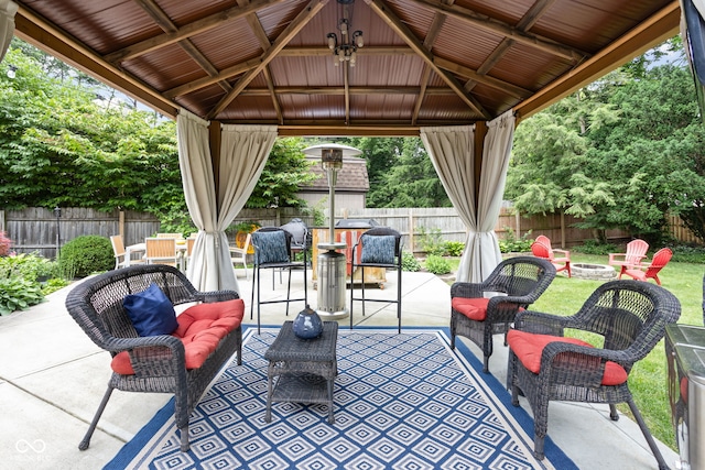 7629 Candlewood Ln, Indianapolis, IN 46250 - fenced backyard with a gazebo, an outdoor living space with a fire pit, and a patio