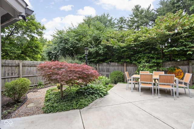 7629 Candlewood Ln, Indianapolis, IN 46250 - fenced backyard featuring outdoor dining space and a patio