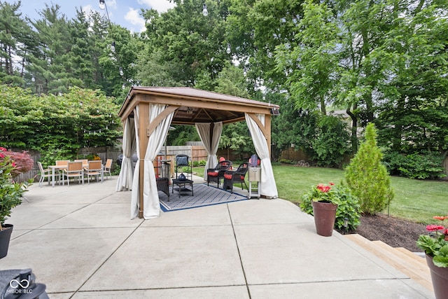 7629 Candlewood Ln, Indianapolis, IN 46250 - fenced backyard featuring a gazebo, outdoor dining space, and a patio area