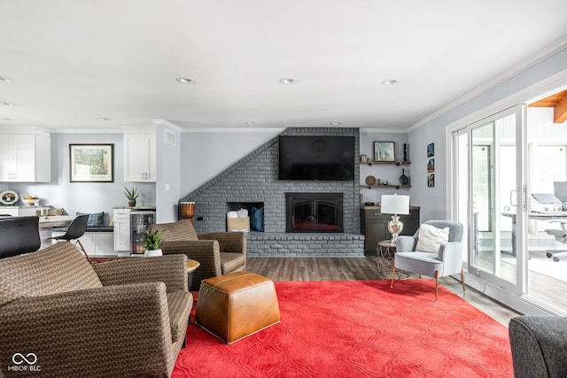 7629 Candlewood Ln, Indianapolis, IN 46250 - living room featuring wood finished floors, beverage cooler, a fireplace, crown molding, and recessed lighting