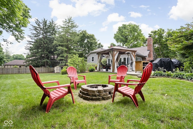 7629 Candlewood Ln, Indianapolis, IN 46250 - view of yard with an outdoor fire pit, a gazebo, and a storage shed