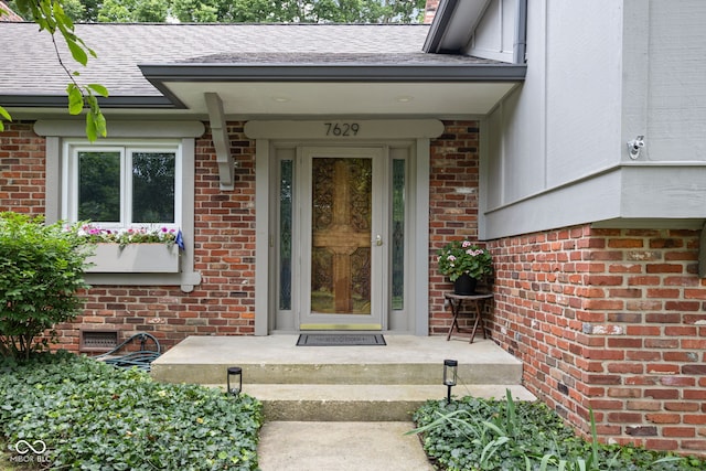 7629 Candlewood Ln, Indianapolis, IN 46250 - property entrance with brick siding and a shingled roof