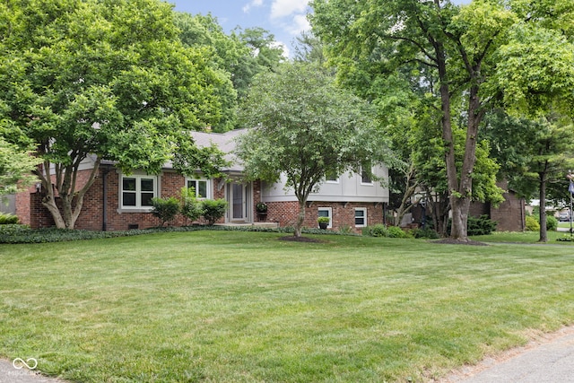 7629 Candlewood Ln, Indianapolis, IN 46250 - view of front of property with a front yard and brick siding