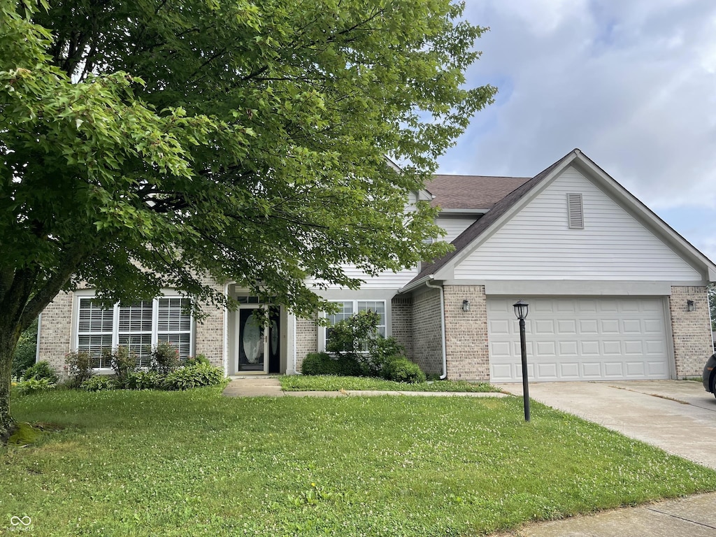 3610 Homestead Pl, Plainfield, IN 46168 - view of front of house with brick siding, concrete driveway, a front lawn, and an attached garage