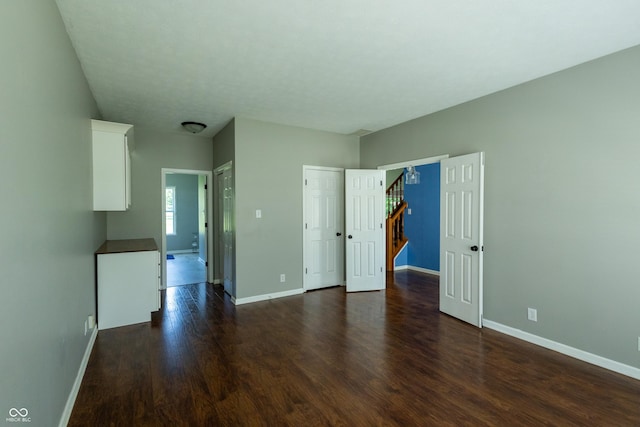 3610 Homestead Pl, Plainfield, IN 46168 - unfurnished living room with baseboards and dark wood finished floors