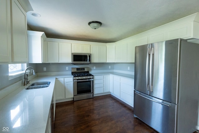 3610 Homestead Pl, Plainfield, IN 46168 - kitchen featuring appliances with stainless steel finishes, white cabinets, dark wood finished floors, and light stone countertops