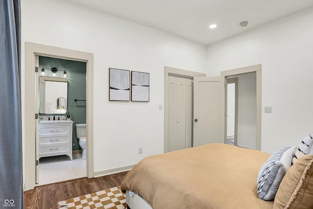 1046 N Hamilton Ave, Indianapolis, IN 46201 - bedroom with dark wood finished floors, ensuite bath, and recessed lighting