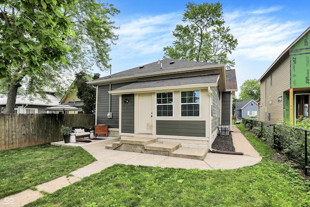 1046 N Hamilton Ave, Indianapolis, IN 46201 - back of property with a patio, a fenced backyard, outdoor lounge area, and a shingled roof