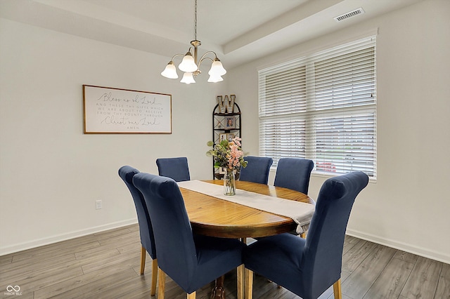 5306 Lavender Dr, Plainfield, IN 46168 - dining space featuring a chandelier, light wood finished floors, and a raised ceiling