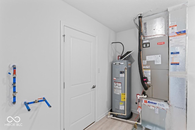 10107 Camp Creek Way, Indianapolis, IN 46229 - utility room with electric water heater and heating unit