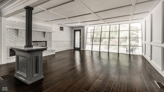 1515 Randall Rd, Indianapolis, IN 46240 - unfurnished living room featuring dark wood-type flooring, a brick fireplace, and coffered ceiling