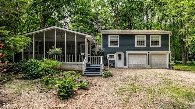1515 Randall Rd, Indianapolis, IN 46240 - view of front of property featuring a sunroom, driveway, view of scattered trees, and stairs