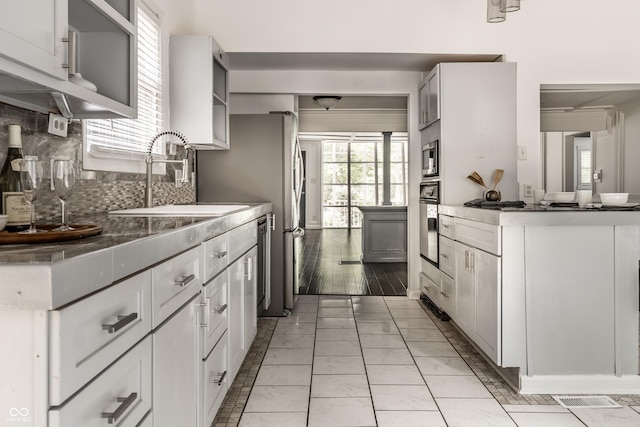1515 Randall Rd, Indianapolis, IN 46240 - kitchen with light marble finish flooring, backsplash, stainless steel appliances, and white cabinets