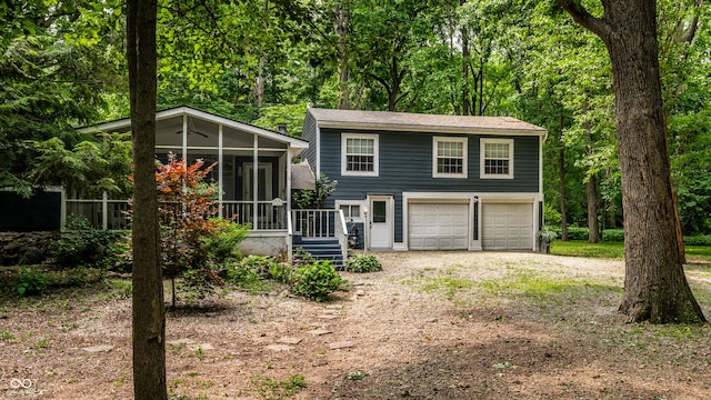 1515 Randall Rd, Indianapolis, IN 46240 - view of front of house featuring dirt driveway, a sunroom, and an attached garage