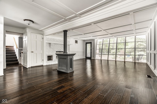 1515 Randall Rd, Indianapolis, IN 46240 - unfurnished living room with dark wood-style floors, stairs, and a wood stove