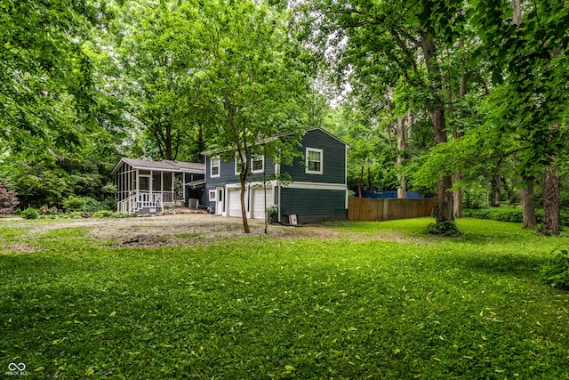 1515 Randall Rd, Indianapolis, IN 46240 - view of yard featuring a sunroom and an attached garage