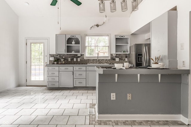 1515 Randall Rd, Indianapolis, IN 46240 - kitchen with stainless steel fridge with ice dispenser, open shelves, gray cabinetry, and healthy amount of natural light