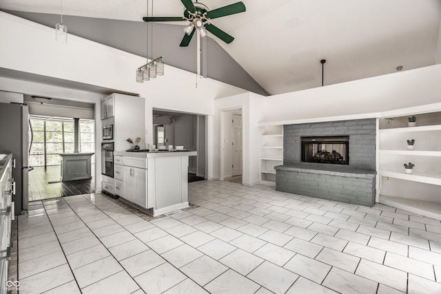 1515 Randall Rd, Indianapolis, IN 46240 - kitchen featuring appliances with stainless steel finishes, a ceiling fan, built in shelves, open floor plan, and high vaulted ceiling
