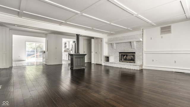 1515 Randall Rd, Indianapolis, IN 46240 - unfurnished living room featuring wood finished floors, a wood stove, and a fireplace