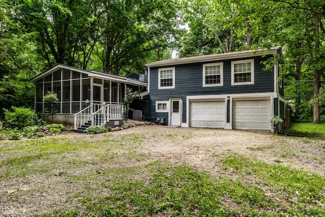 1515 Randall Rd, Indianapolis, IN 46240 - view of front of home with a sunroom, driveway, and an attached garage