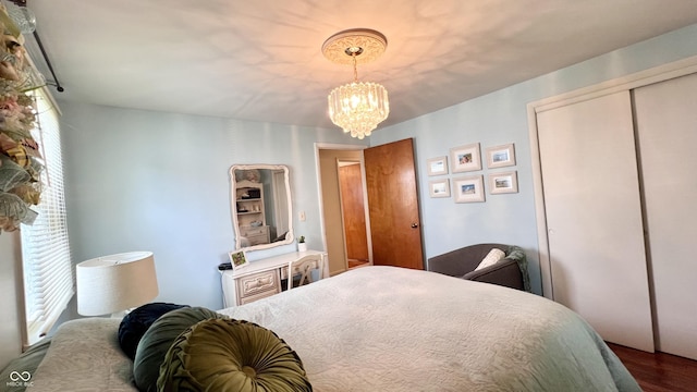 202 Collier St, Columbus, IN 47201 - bedroom with a chandelier, a closet, and wood finished floors