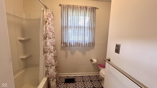 202 Collier St, Columbus, IN 47201 - bathroom featuring shower / bath combination with curtain and tile patterned floors