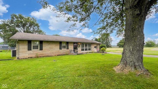 202 Collier St, Columbus, IN 47201 - rear view of property featuring stone siding, a lawn, and a shingled roof