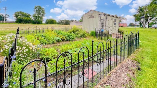 202 Collier St, Columbus, IN 47201 - gate featuring a storage shed, a garden, and a view of countryside