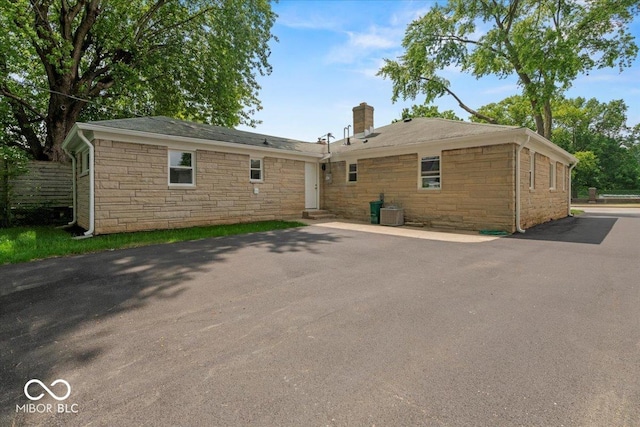 508 W 38th St, Indianapolis, IN 46208 - back of house with a chimney and stone siding
