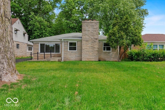 508 W 38th St, Indianapolis, IN 46208 - rear view of house with a yard, a chimney, stone siding, and roof with shingles