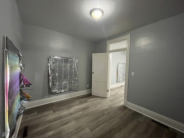 3127 E Lynn St, Anderson, IN 46016 - unfurnished bedroom with wood finished floors and baseboards