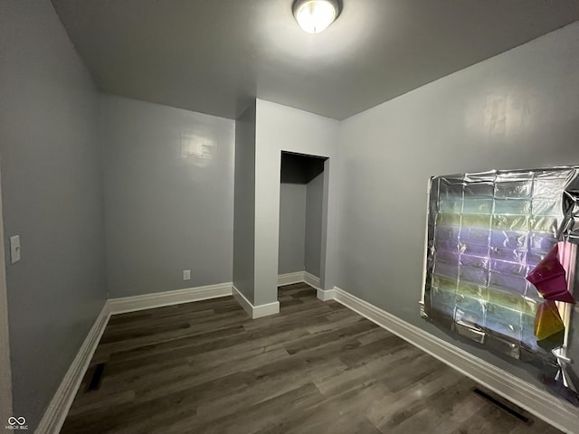 3127 E Lynn St, Anderson, IN 46016 - unfurnished room featuring dark wood finished floors and baseboards